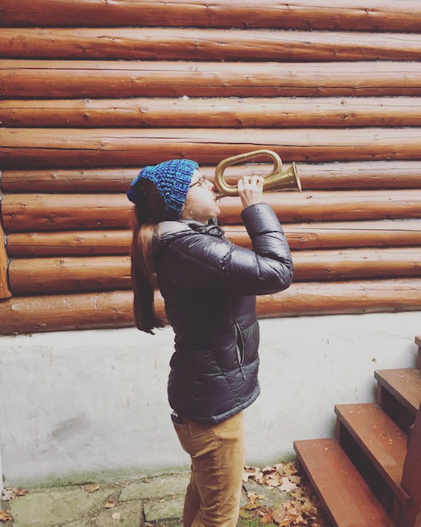 A photograph of Vedis playing a trumpet.