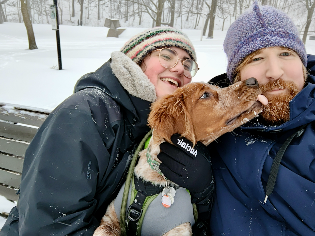 Leif, Gersande, with Pippin between them, posing for a shoulders-up selfie in winter gear.