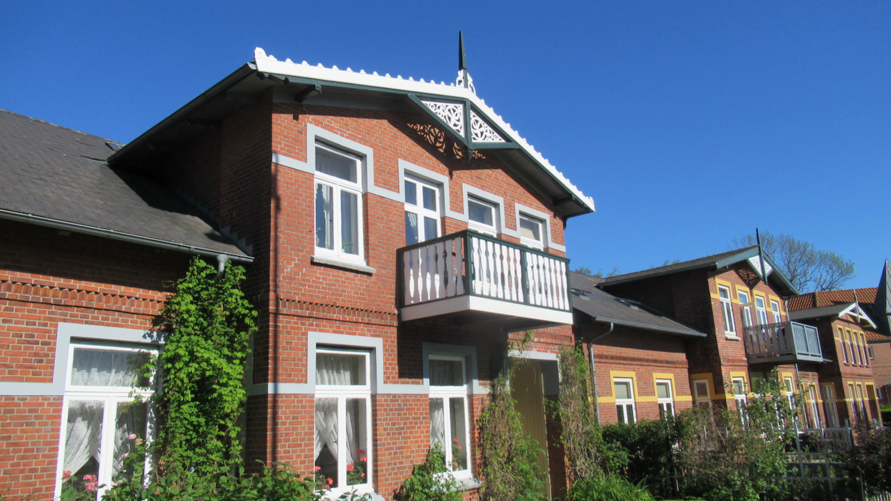 Brick row-houses with charming wooden balconies and bargeboards.