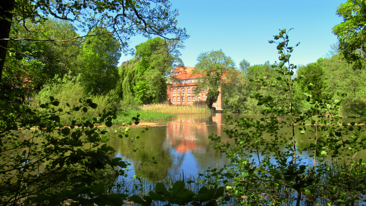 The old and very large seminary across the Vidå, surrounded by enough trees that it looks secluded in the wilderness.